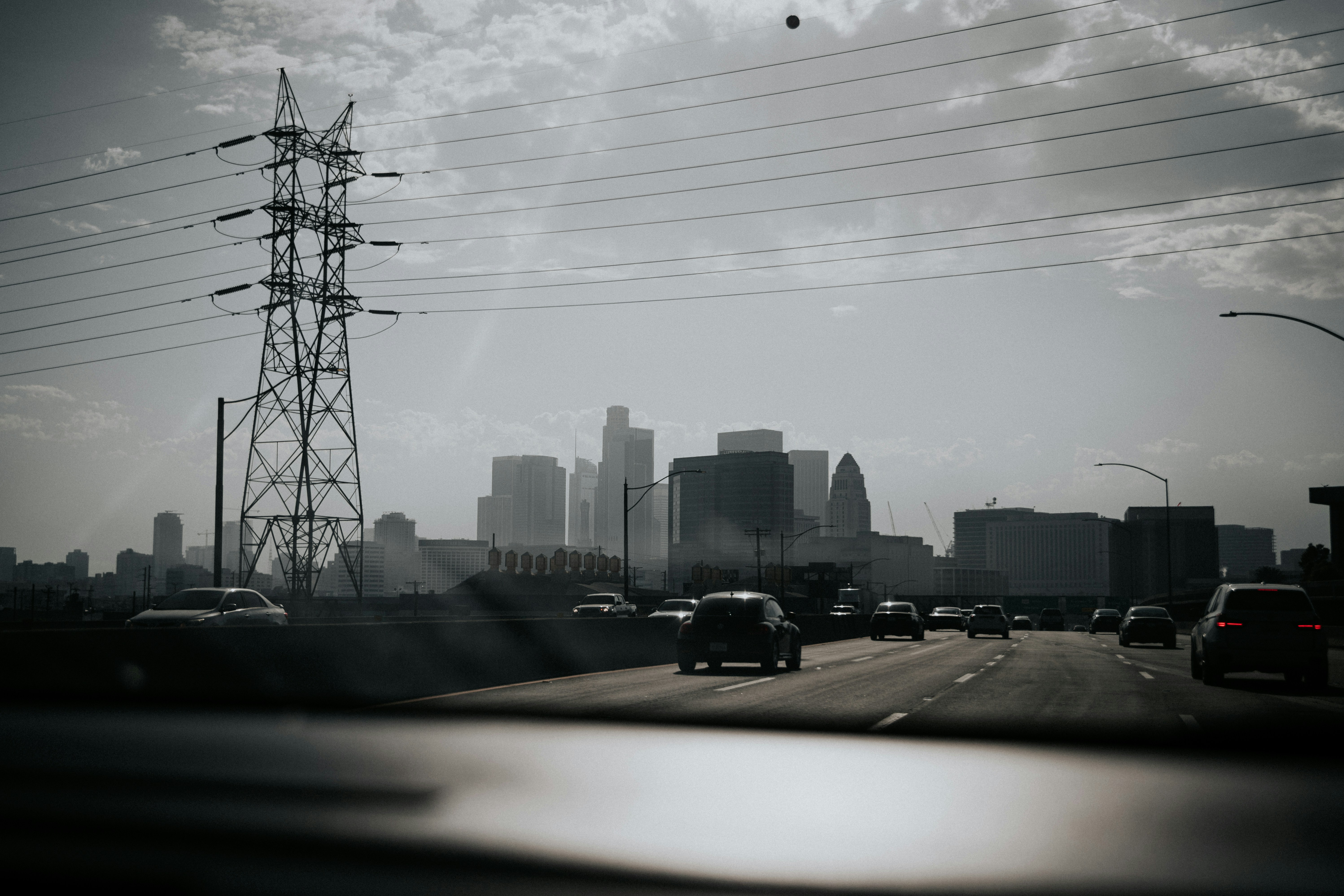 cars on road near city buildings during daytime